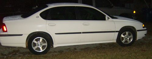 White w/ tinted windows. 03 chevrolet impala w/ 3.8 litre, alloy wheels.
