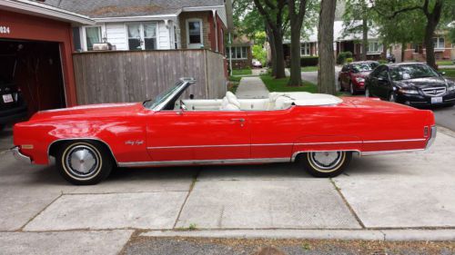 1970 olds ninety-eight red convertible with a great white top.