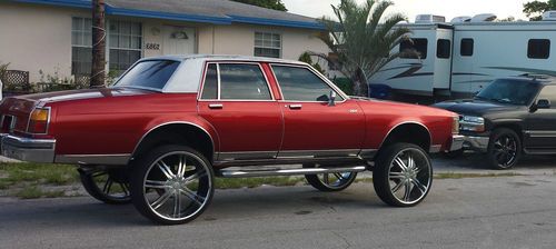 1984 olds delta 88 , candy red , 26 inch rims,professional lift,no cut no rubb