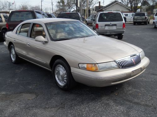 1997 lincoln continental, gold, runs great with low mileage.