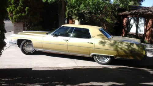 1973 cadillac sedan deville, in good working order, gold color, leather interior