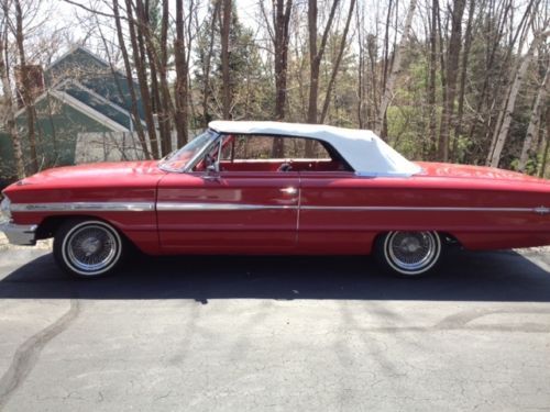 1964 ford galaxy convertible, red body with white top.