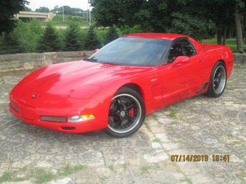 Sports car 2004 z06 corvette red w/ black rims, nitto tires,kooks headers.430hp