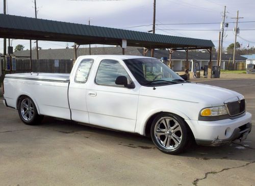 Customized white 1993 ford f250 pick up truck