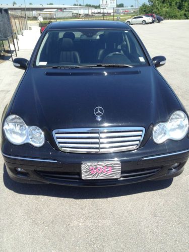 Four door, black interior and exterior, leather seats, heated seats, cd player