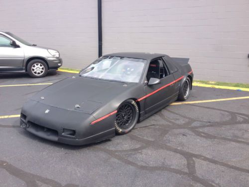 Race ready fiero with race trailer, tires, suit, helmet and harness, hans device