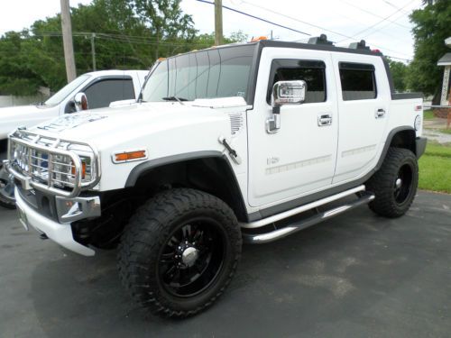White hummer h2 sut with black rims and 35&#034; tires