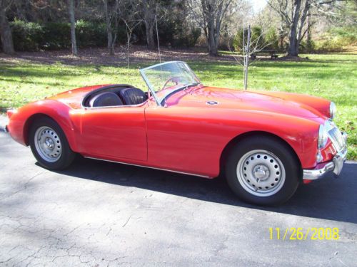 Beautiful 1959 mga twin cam roadster, orient red, black interior, black top.