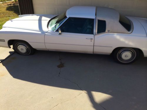 White with light blue interior. low miles 78,000, runs and drives.